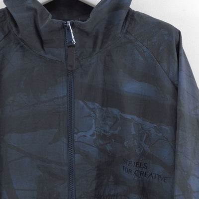 【S.F.C/エスエフシー】<br>WINDBREAKER JACKET (REAL TREE CAMO) <br>SFCFW25J06